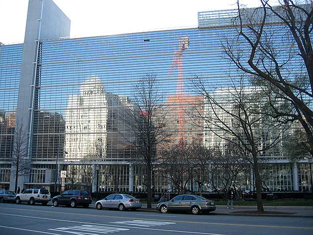 Buildings on Pennsylvania avenue reflected in the windows of the World Trade Organization building.