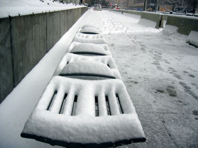 Snow covers the mostly decorative benches outside the World Bank building.