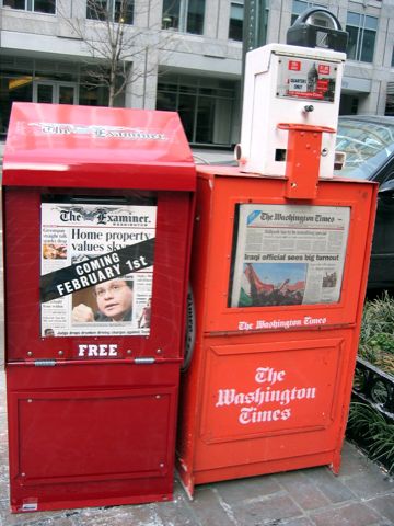 A shiny red newspaper box announces the new free paper in D.C., the Examiner.