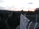 The sunset sky, a bridge, and a road, from a bridge.