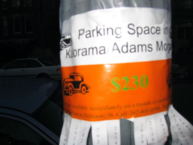 A flyer pasted on an Adams Morgan lightpost advertises parking spots in the neighborhood for $230/month.