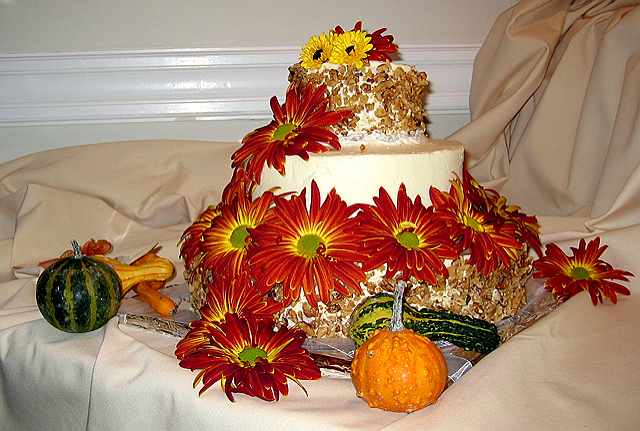 Wedding cake decorated w/real flowers.