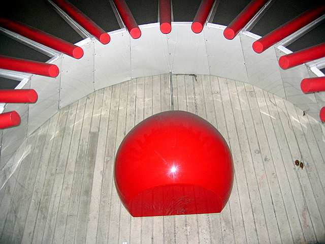 A red ball sculpture and part of its red rays at the Gallery Place metro station.