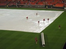 Grounds crew pushed water off the tarp.