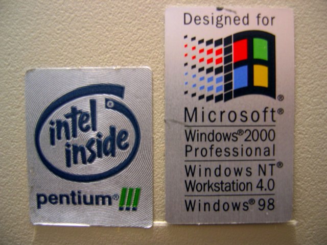 Branding badges on the aged computers I use at work.