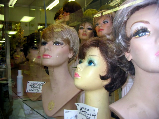 A display of wigs for women in a storefront in downtown Alexandria, VA.