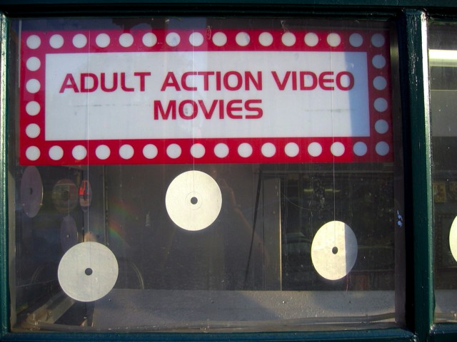 A sign in a Chinatown video rental store window.