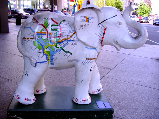 A white elephant carries Metro maps on its back in front of the MLK Jr. Library near the Gallery Place Metro station.