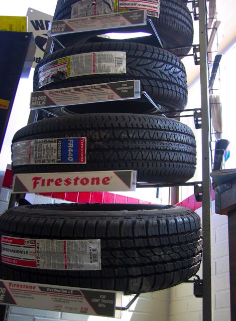 A display of tires inside the lobby of a Midas store.