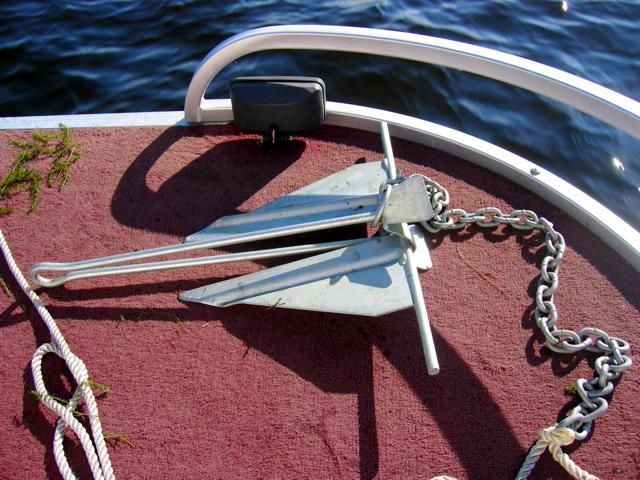 The anchor sitting on the deck of the pontoon as we cruise across the lake.