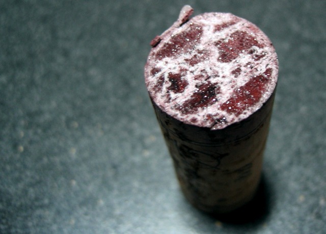 The bottom of a cork pulled from a bottle of wine apparently past its prime.