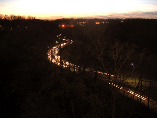 Traffic heading north on Rock Creek Drive at dusk.