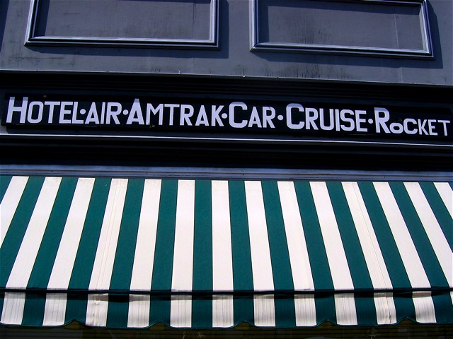 A travel agency sign on U St. NW.