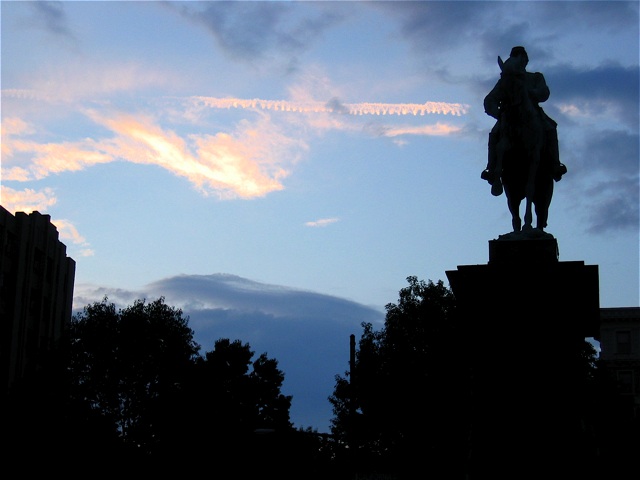 The setting sun creates a silhouette along Connecticut Ave near the intersection of Columbia.