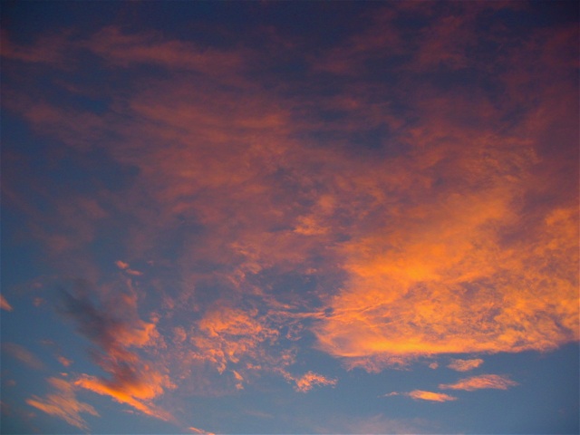 The setting sun infuses the clouds with color over Red Lodge.